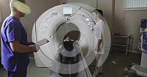 4K Â Man getting out MRI scanning table.